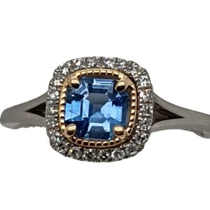 Platinum and 14 Karat Yellow Gold Cushion Cut Sapphire and Diamond Halo Ring