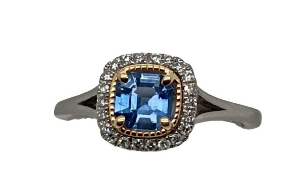 Platinum and 14 Karat Yellow Gold Cushion Cut Sapphire and Diamond Halo Ring